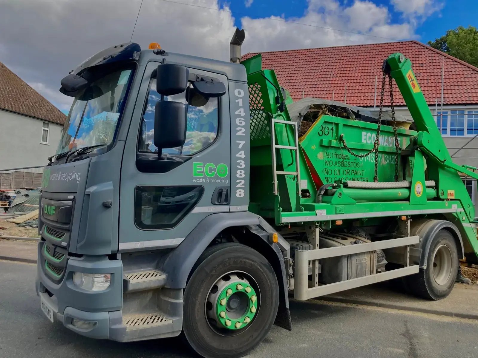 Skip hire Hitchin, Hertfordshire delivery by an Eco skip loader lorry parked outside a house Skip hire Hitchin, Hertfordshire delivery by an Eco skip loader lorry parked outside a house